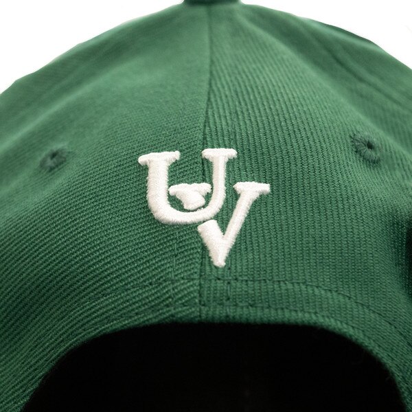 CapX forest green structured adjustable hat from the back with a vintage white UV logo on the back